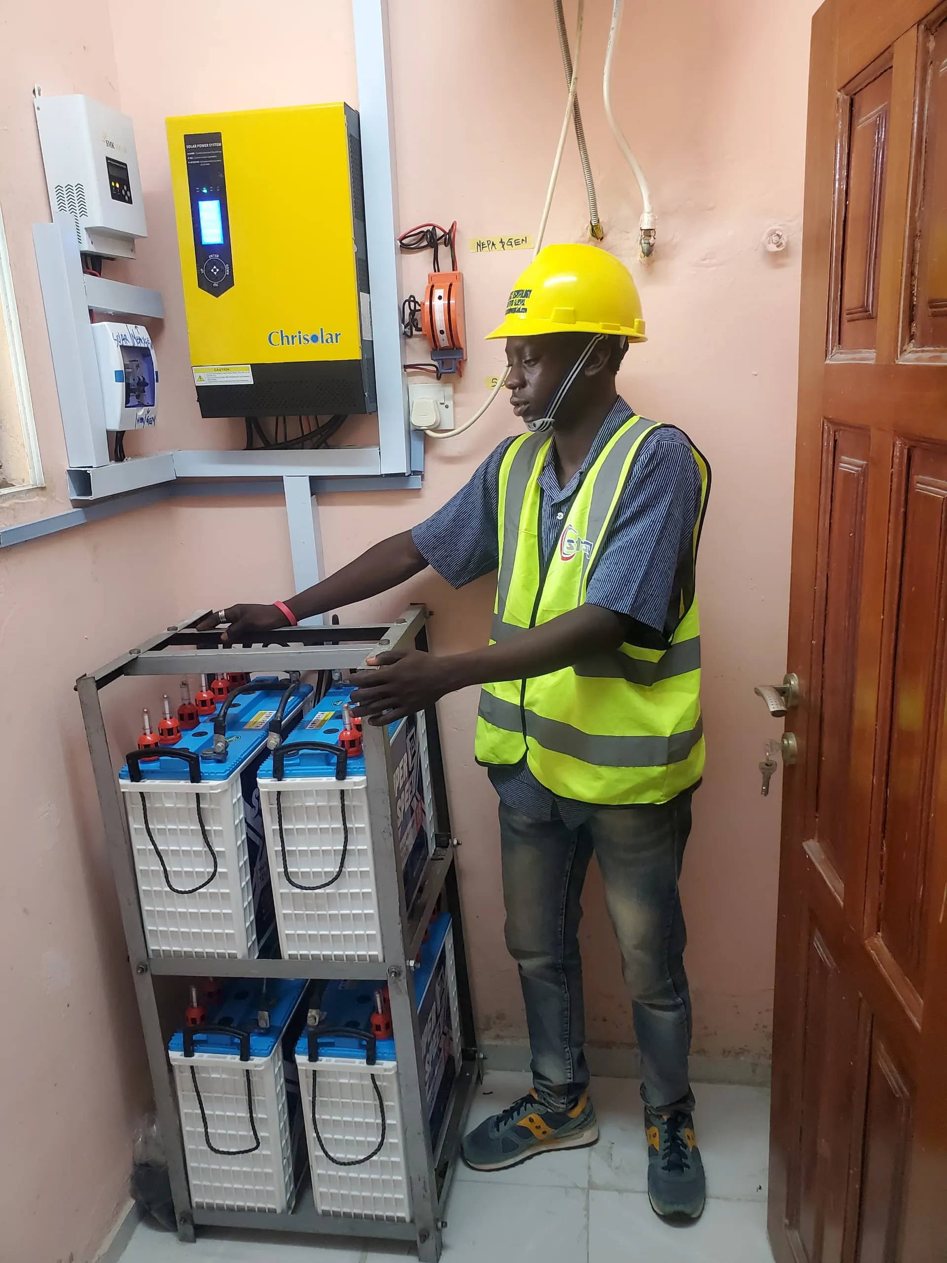 Founder Olaleru Abdulrahman inspecting a solar power installation.